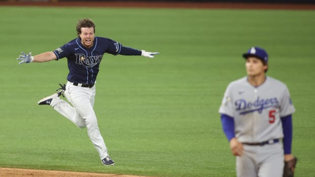 Oct 24, 2020; Arlington, Texas, USA; Tampa Bay Rays right fielder Brett Phillips (14) celebrates after driving in the winning run as Los Angeles Dodgers shortstop Corey Seager (5) looks on during the ninth inning of game four of the 2020 World Series at Globe Life Field. Mandatory Credit: Tim Heitman-USA TODAY Sports